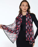 Switch Woman wearing a colorful scarf with elephant pattern on a white background 3 image