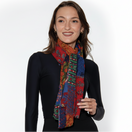 Switch Woman wearing a colorful patterned scarf on a white background. 2 image