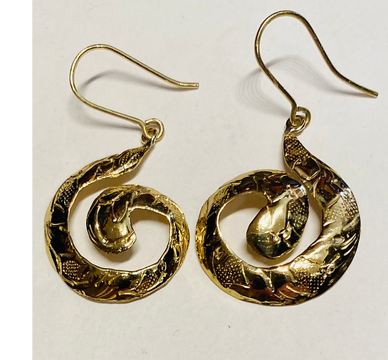 A pair of gold-colored brass earrings with an engraved spiral design.