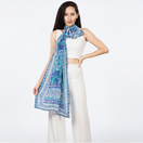 Switch Woman wearing a blue patterned scarf on a white background. 2 image