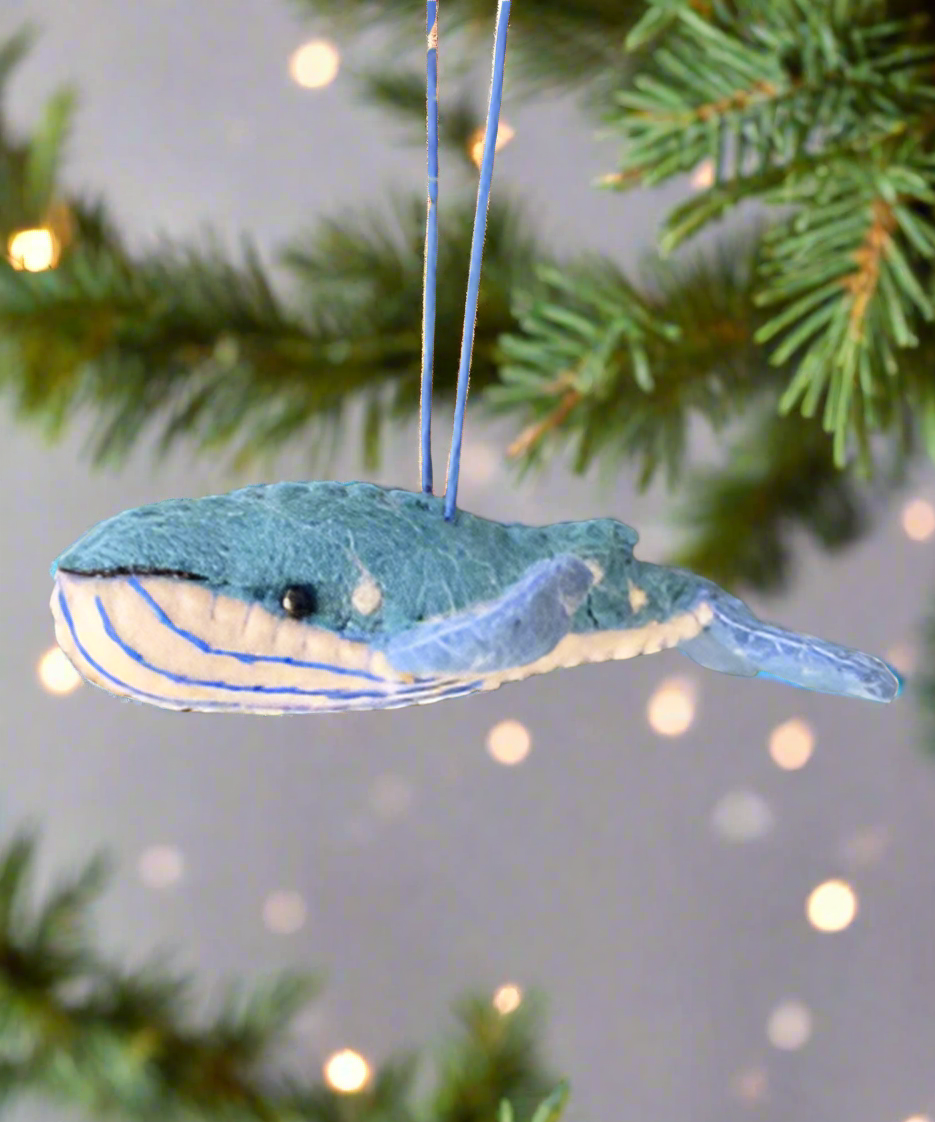 a humpback whale ornament hanging on a tree