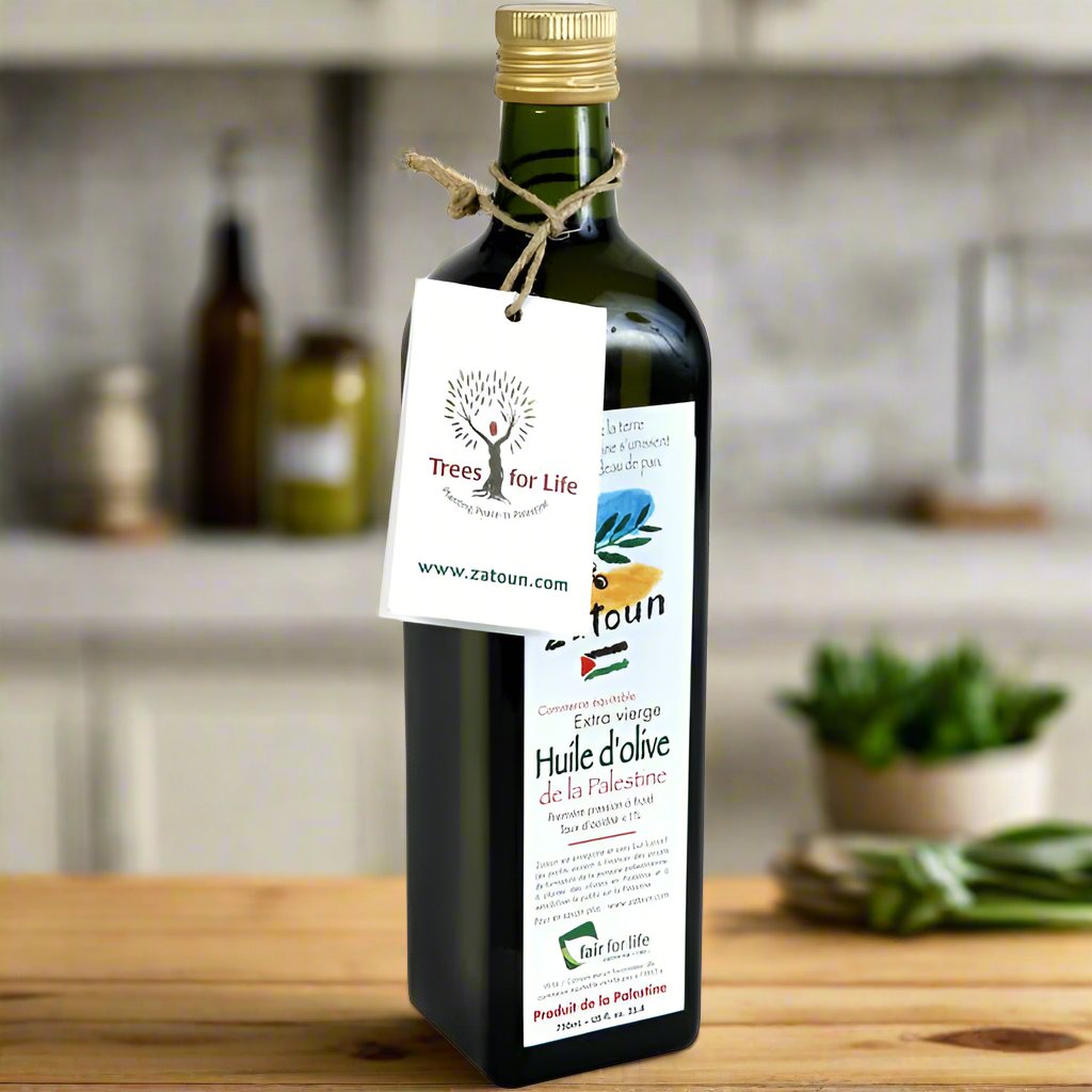 A bottle of Zatoun Extra Virgin Olive Oil, dark glass bottle with a cork, labeled with the brand name and other details.