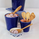 Switch Blue ceramic cups with pink ice cream and wooden spoons on a white surface. 2 image