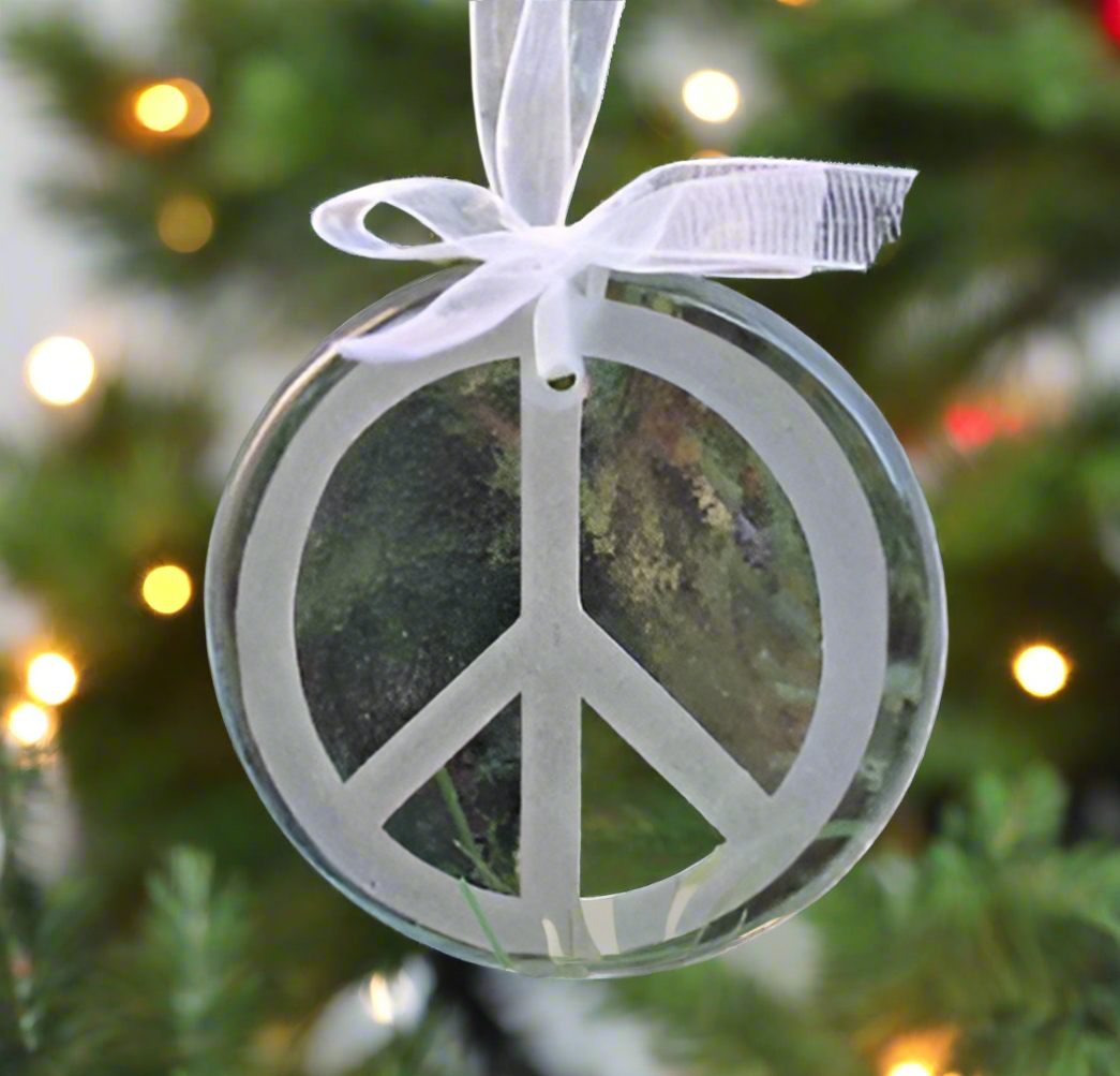 a glass ornament engraved with the peace sign