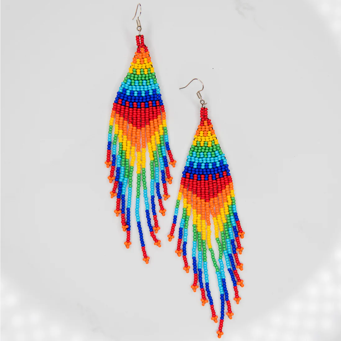 Colorful beaded earrings on a light gray background