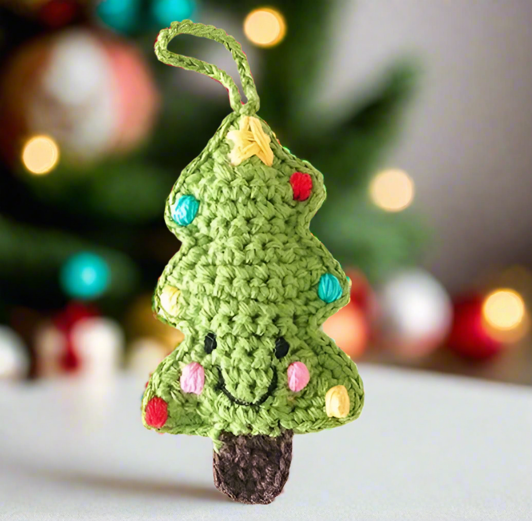 a hand-knit smiley Christmas tree ornament