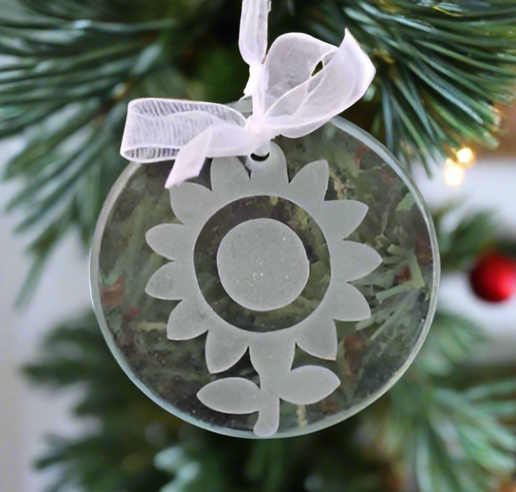 a glass ornament engraved with the illustration of a sunflower