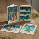 Switch assorted batik Christmas cards laying on a table 2 image