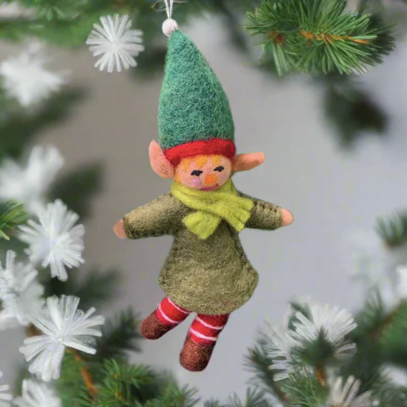 a handcrafted elf girl tree ornament wearing a green dress and hat