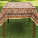 Switch Decorative tablecloth with intricate patterns on a wooden table outdoors. 2 image