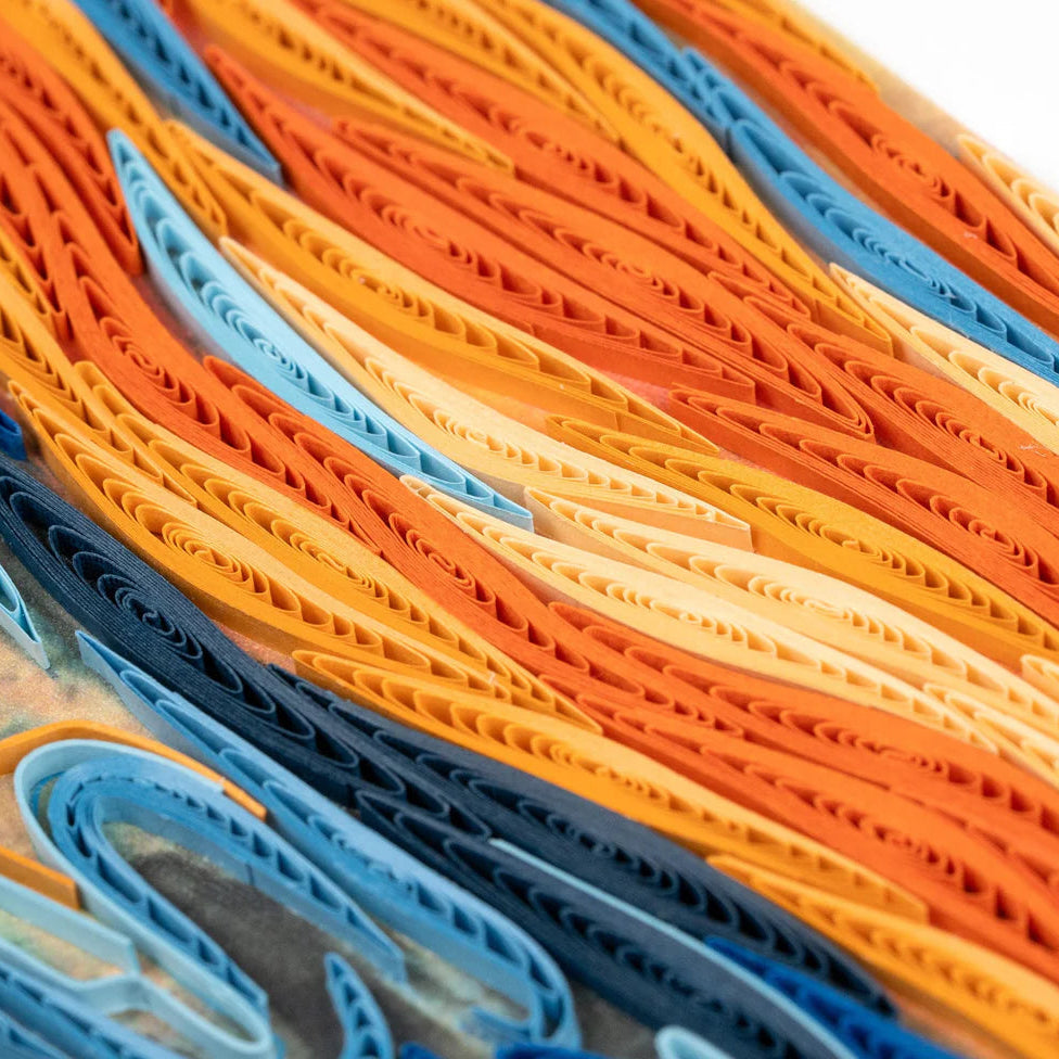Close-up of colorful paper art in orange, blue, and yellow.