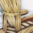 Switch Artistic paper sculpture of a cross on a textured surface 3 image