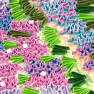 Switch Colorful creased paper flower-shapes on a textured surface. 2 image