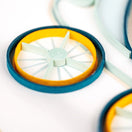 Switch Close-up of a blue and yellow quilled paper object on a white background 3 image