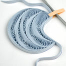 Switch Blue quilled paper sculpture on a white background 2 image