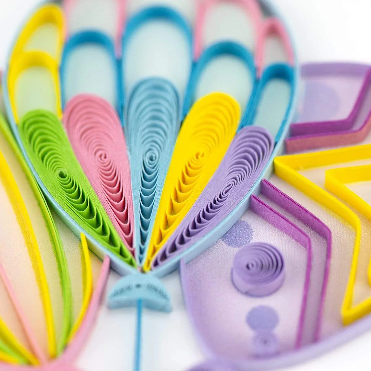 Colorful paper quilling shapes on a white background