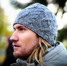 Switch A person wearing a gray beanie with a cable knit pattern. 2 image