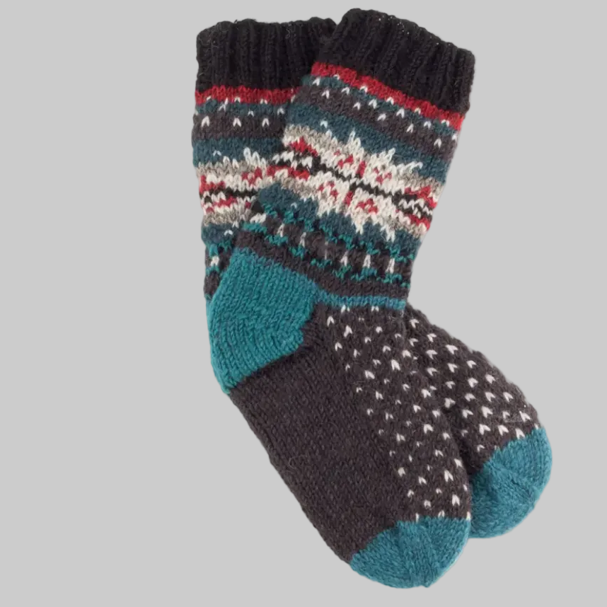 A pair of hand-knitted wool socks with subtle two-tone patterns and overstitch embroidery along the ankle, primarily in black, gray, and blue colors.
