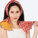 Switch Woman wearing a red floral headscarf and yellow shawl with embroidery on a white background 1 image