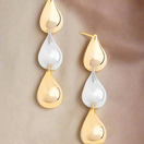 Switch close up shot of gold and silver teardrop earrings 2 image