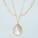 Switch A gold-layered necklace with a scalloped teardrop mother of pearl pendant on a white background. 3 image