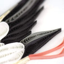 Switch Close-up of black, white, and red folded paper on a white background 3 image