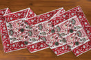 Switch Stack of red and white patterned placemats on a wooden surface 3 image