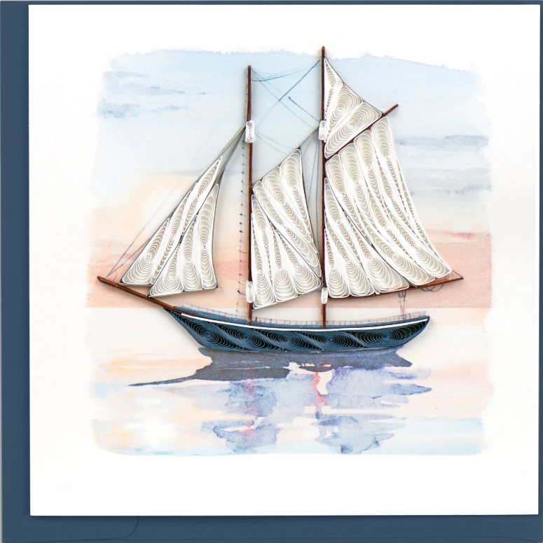 Decorative paper art of a sailboat with white sails on a blue background
