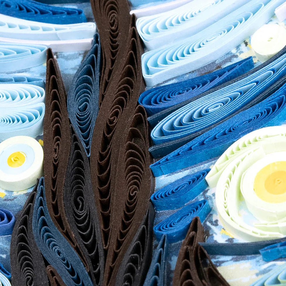 Close-up of a paper quilling art piece with blue, brown, and white colors.