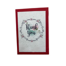 Switch A folded greeting card with a floral design and the words 'Thank You' in the center, on a white background with a red envelope. 2 image